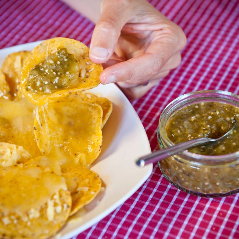 Hot and spicy Mexican salsa verde goes down a treat with corn chips and cheese.(© All Rights Reserved)